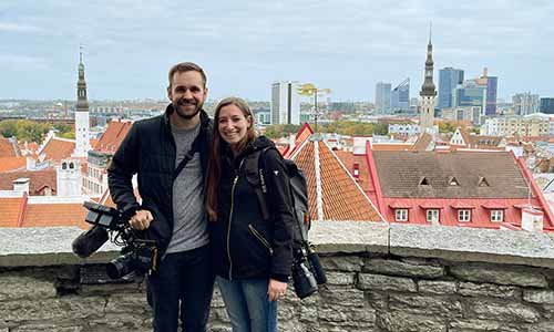 Couple smiling with video equipment