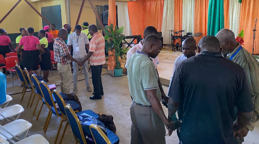 Praying at conference in Haiti