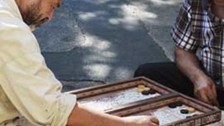 Men playing checkers in park