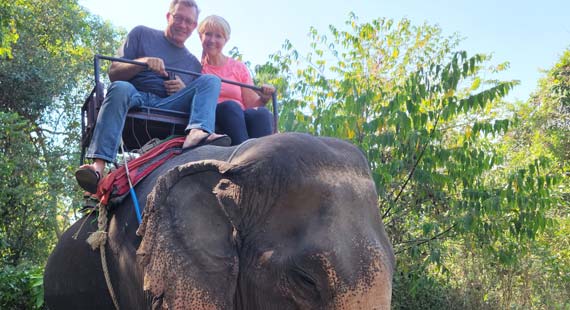 Couple riding elephant