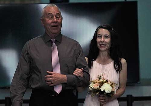 Couple walking down isle